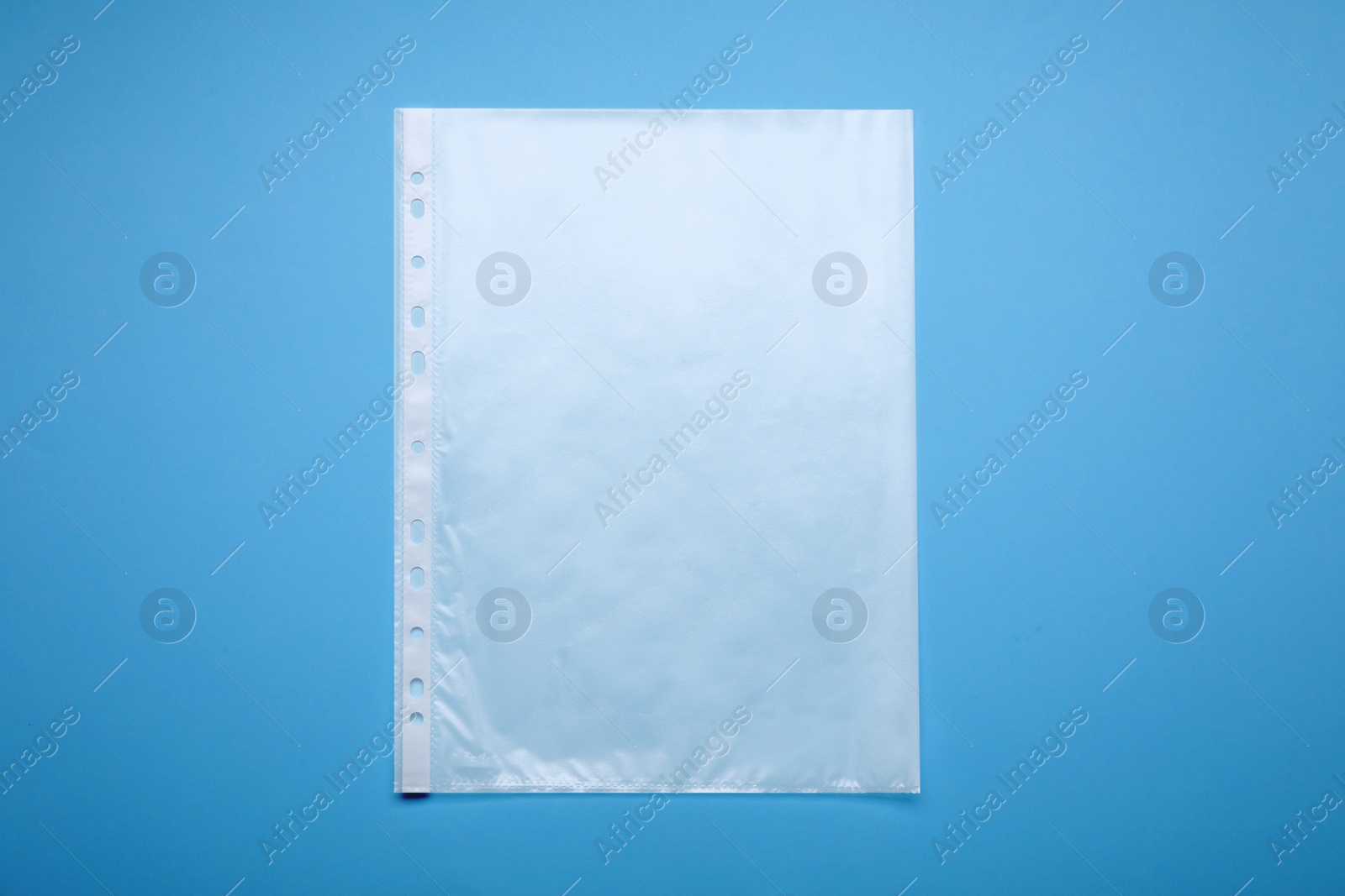 Photo of Punched pocket on light blue background, top view