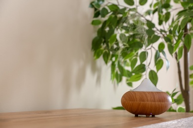 Aroma oil diffuser lamp on table indoors