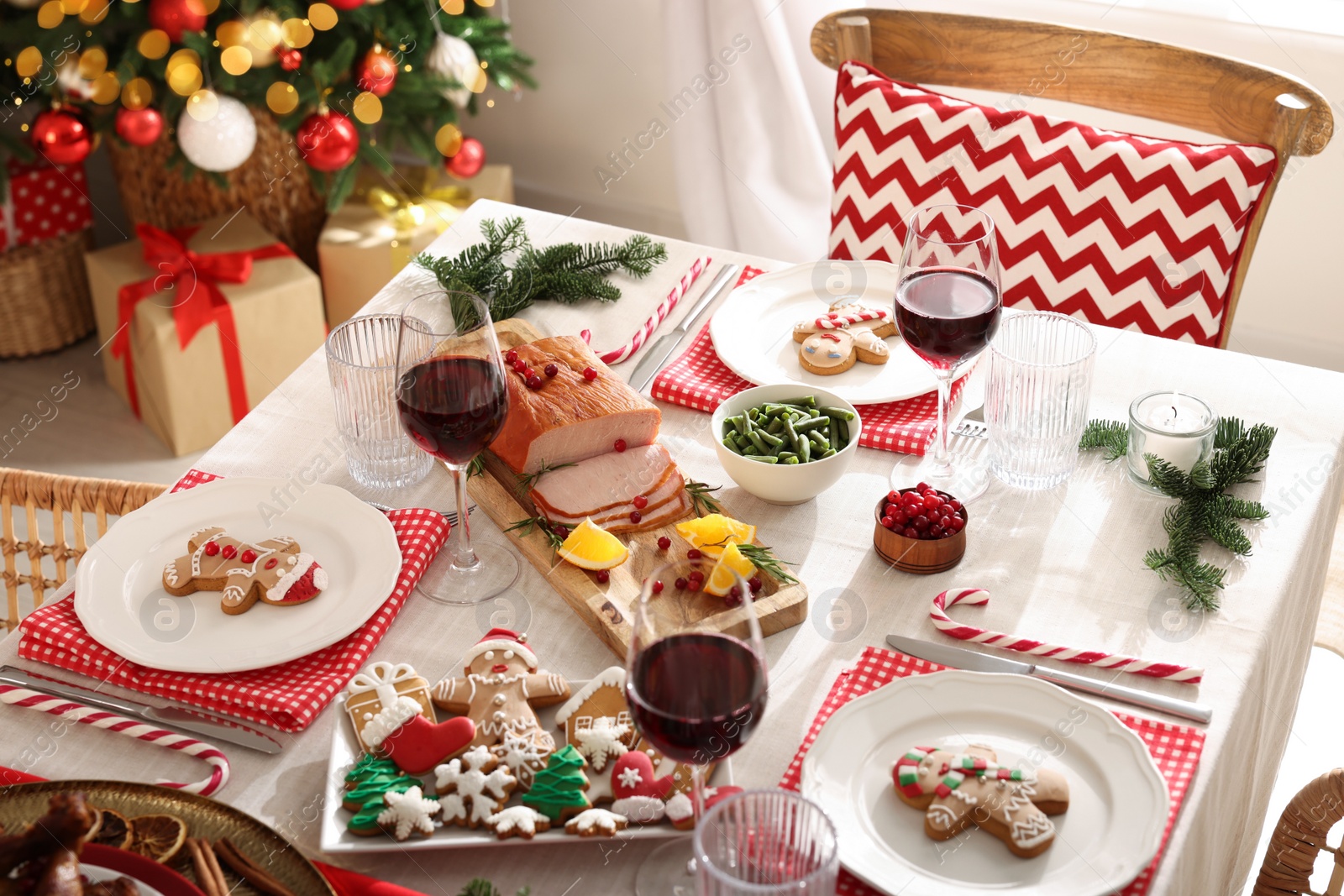 Photo of Festive dinner with delicious food and wine on table indoors. Christmas Eve celebration