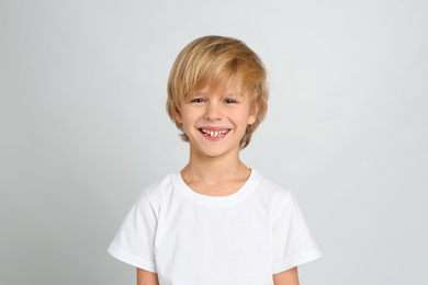 Photo of Happy little boy on light grey background