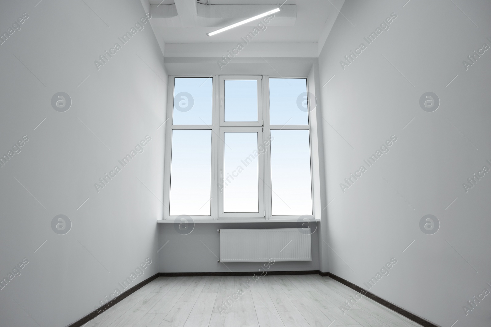 Photo of New empty room with clean windows and white walls