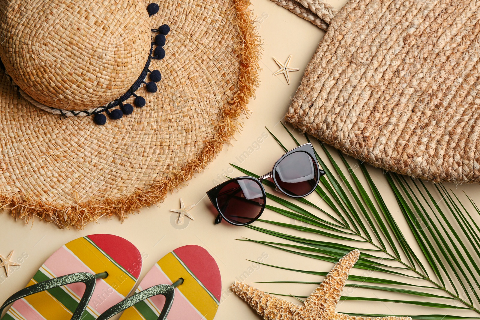 Photo of Flat lay composition with sunglasses and beach accessories on beige background