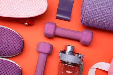 Photo of Different sports equipment on orange background, flat lay