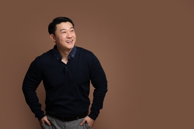 Photo of Portrait of happy man on brown background. Space for text