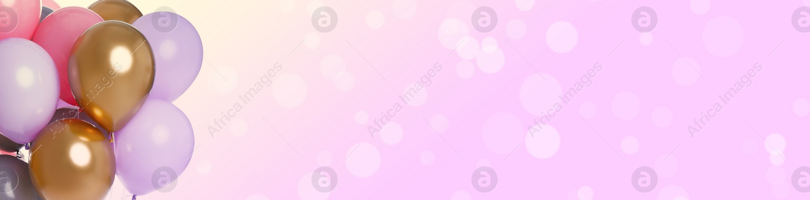Image of Bright balloons on color background with bokeh effect, space for text. Banner design