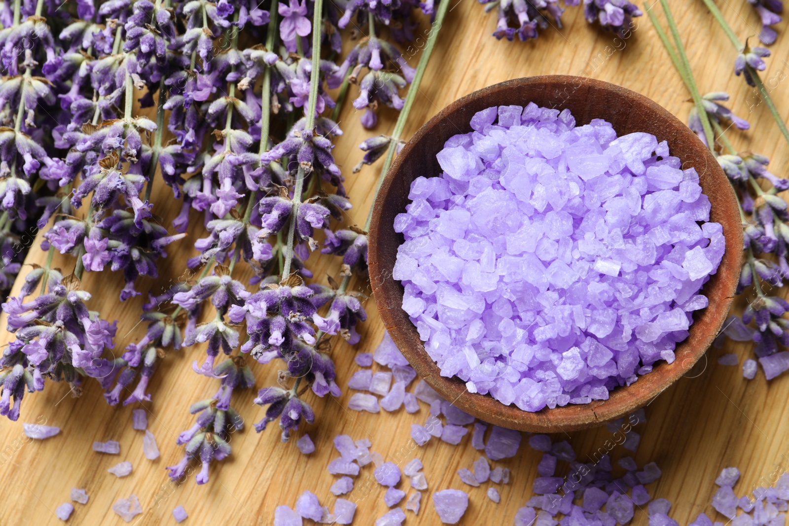 Photo of Flat lay composition with natural lavender bath salt and flowers on wooden board. Cosmetic product