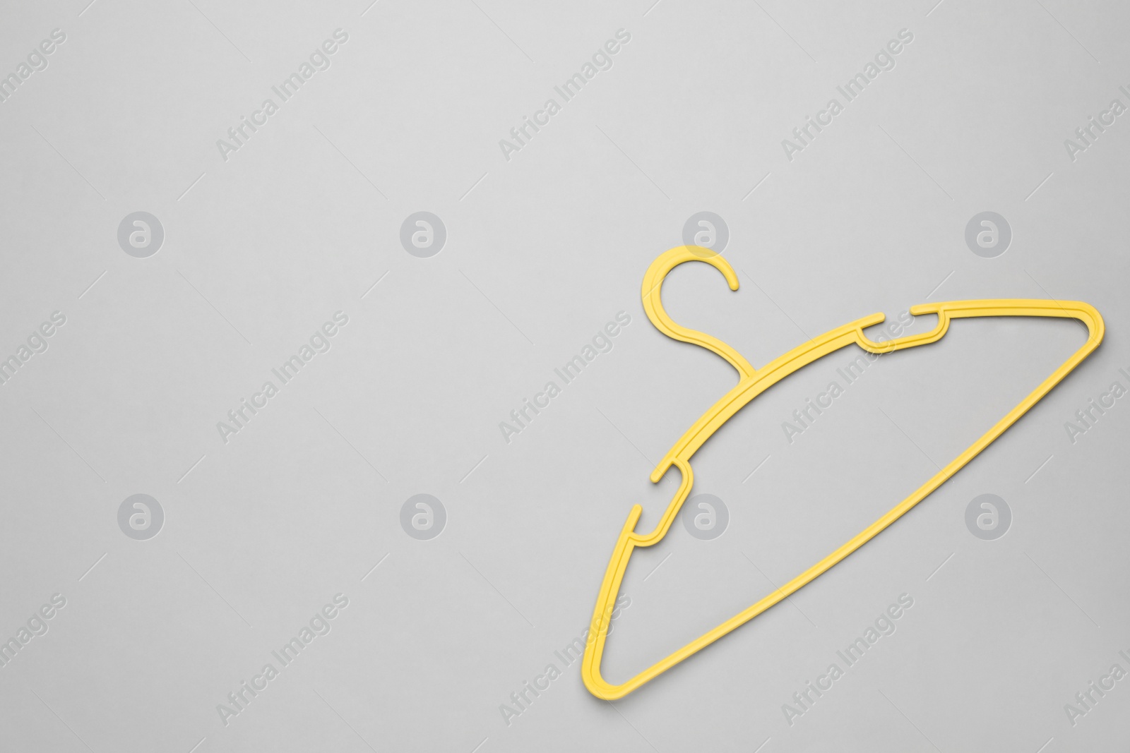 Photo of Empty clothes hanger on white background, top view. Space for text