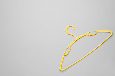 Photo of Empty clothes hanger on white background, top view. Space for text