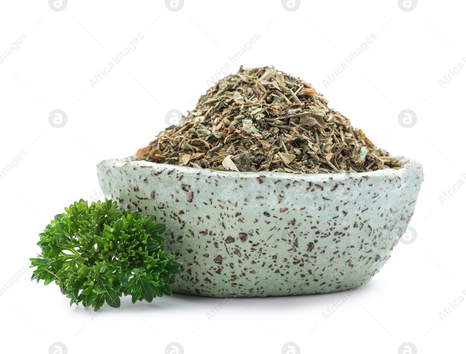 Photo of Bowl with dried parsley on white background