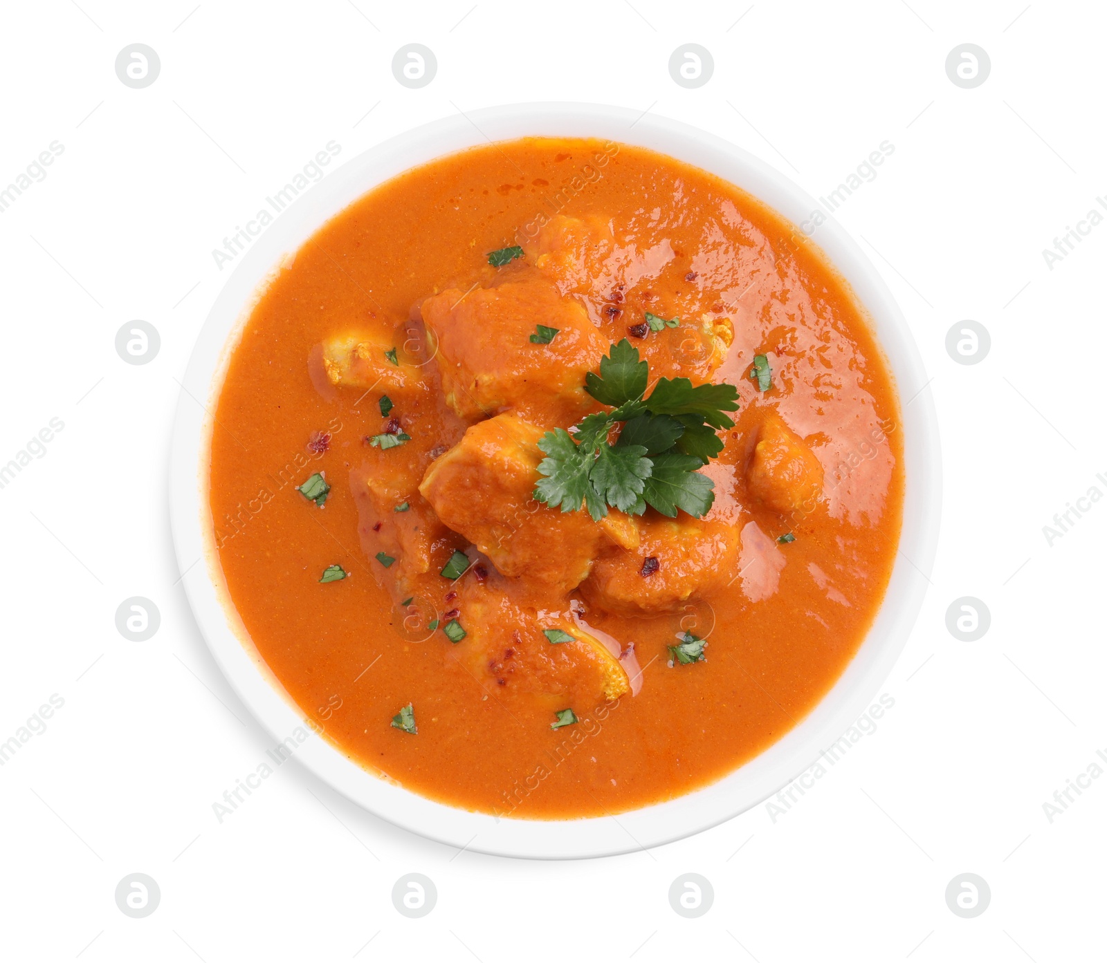 Photo of Bowl of delicious chicken curry on white background, top view