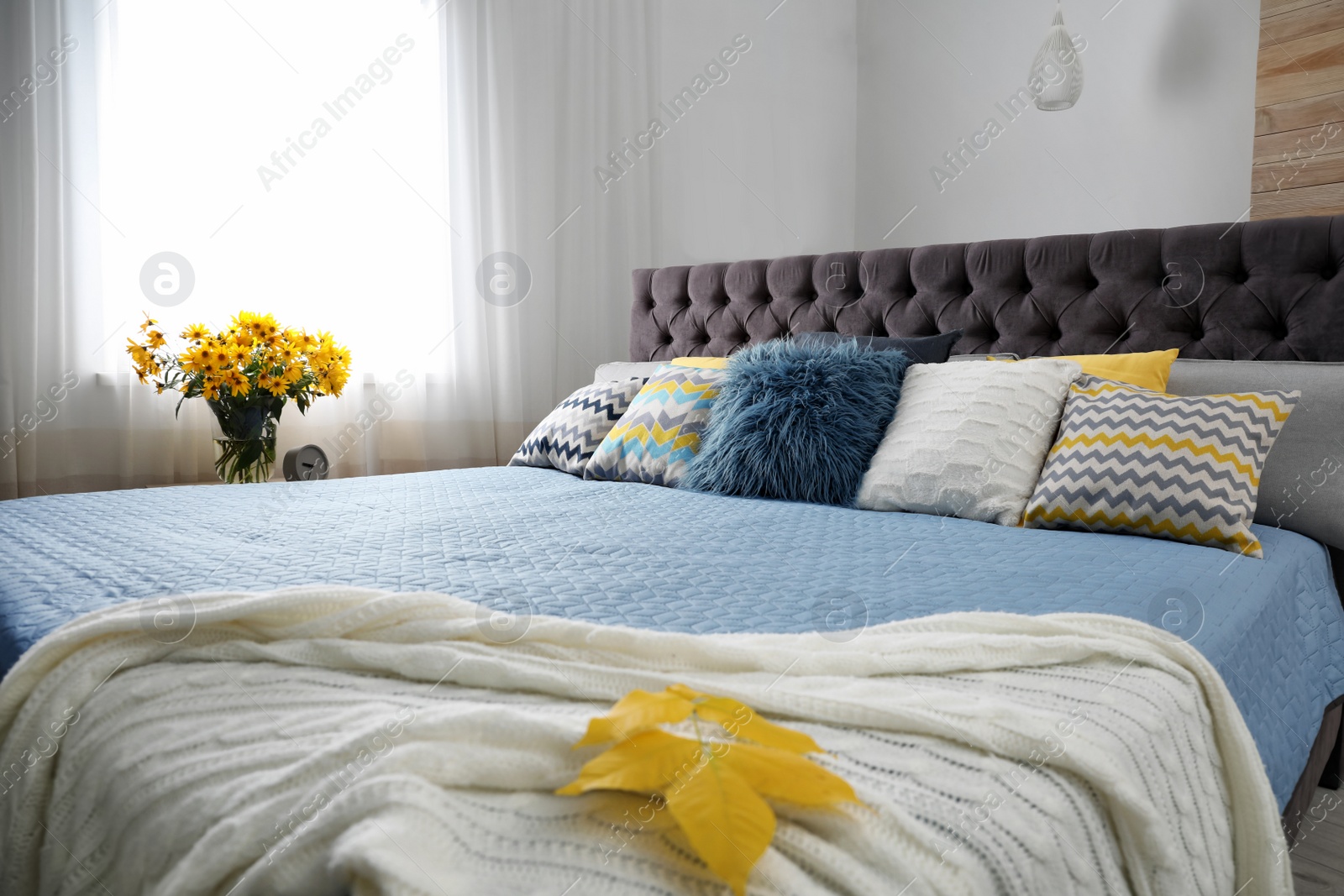 Photo of Different pillows on bed in room. Idea for interior decor