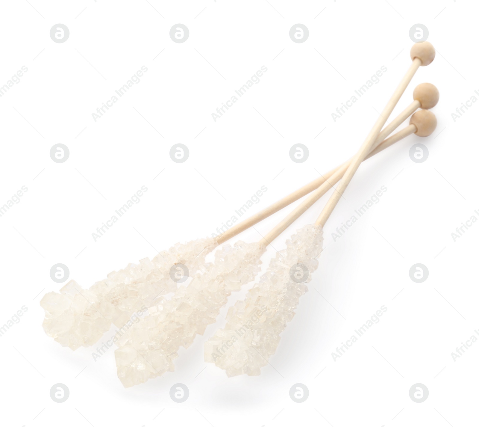 Photo of Wooden sticks with sugar crystals isolated on white. Tasty rock candies