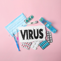 Photo of Flat lay composition with word VIRUS and medicines  on pink background