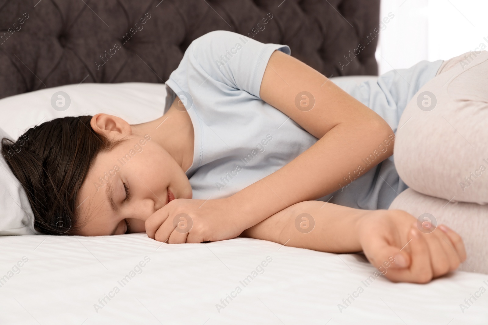 Photo of Cute little girl sleeping in bed at home