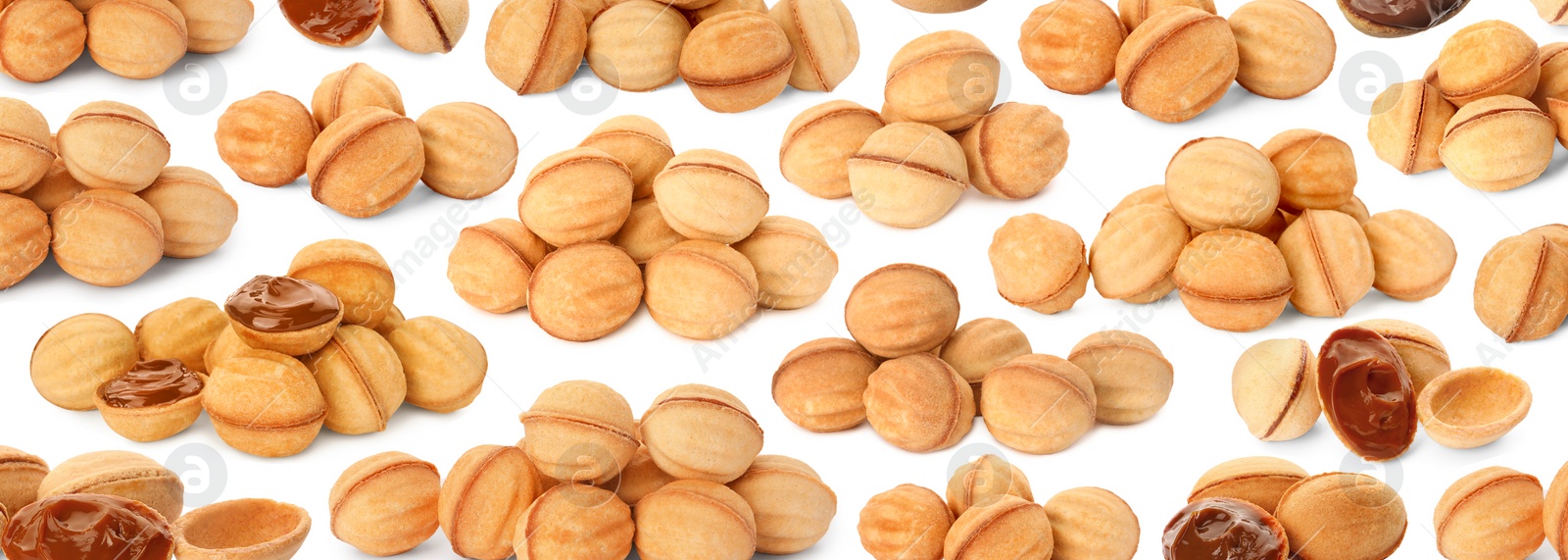 Image of Many delicious nut shaped cookies with caramelized condensed milk on white background. Pattern design