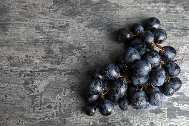 Photo of Fresh ripe juicy grapes and space for text on table, top view