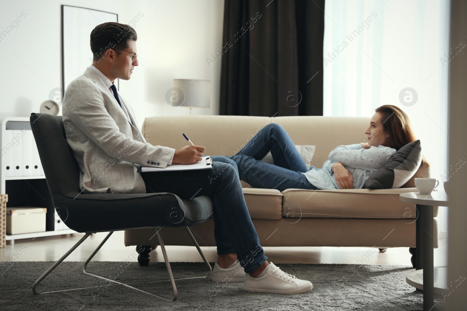 Photo of Professional psychotherapist working with patient in office