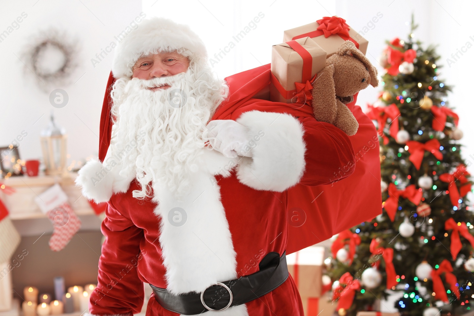 Photo of Authentic Santa Claus with bag of gifts indoors