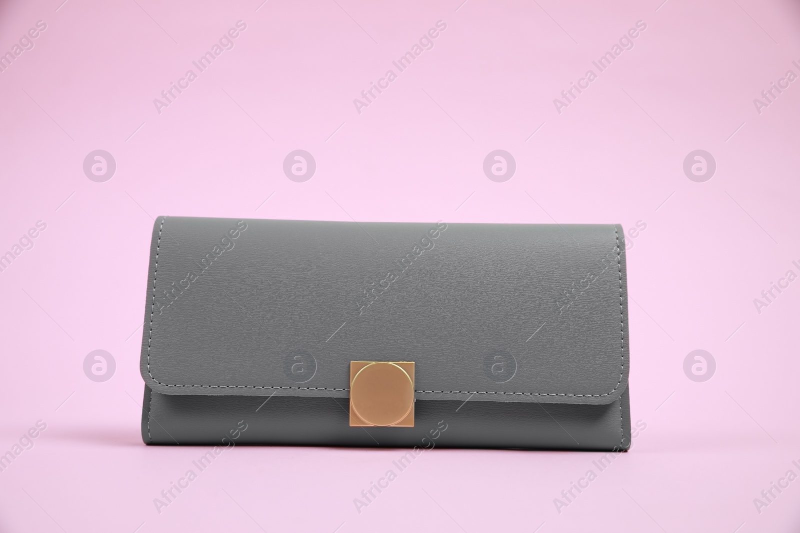 Photo of Stylish grey leather purse on pink background