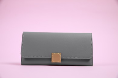 Photo of Stylish grey leather purse on pink background