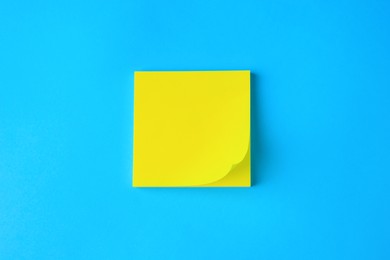 Photo of Blank paper note on light blue background, top view