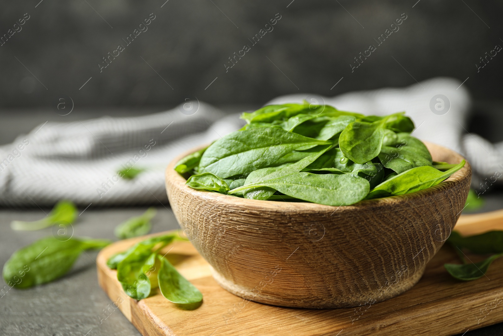 Photo of Fresh green healthy spinach on grey table