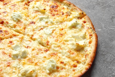 Delicious hot cheese pizza on grey background