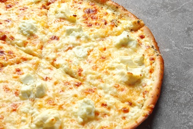 Photo of Delicious hot cheese pizza on grey background