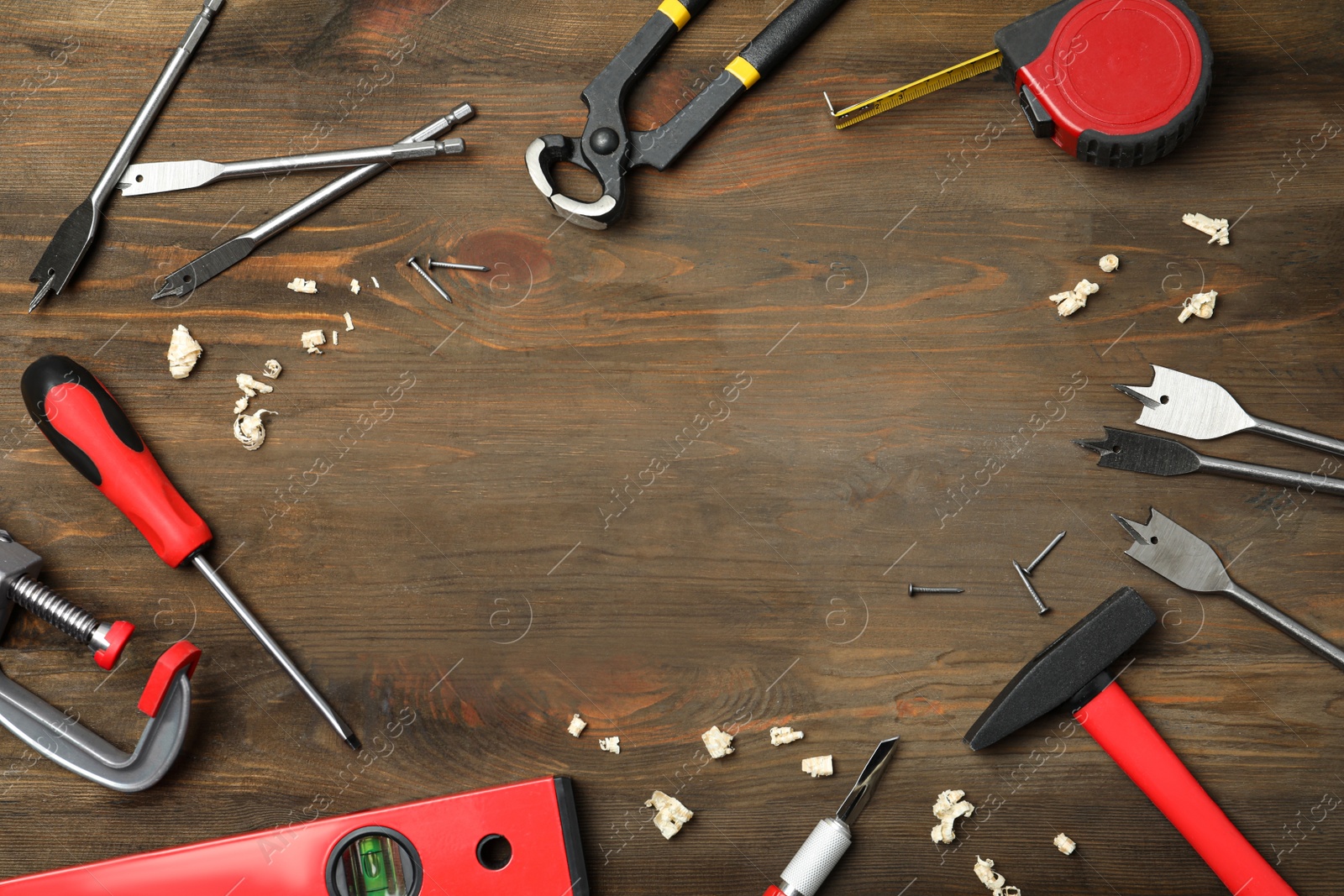 Photo of Flat lay composition with carpenter's tools on wooden background. Space for text