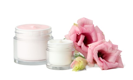 Jars of body cream on white background