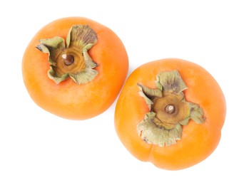 Whole delicious juicy persimmons on white background, top view