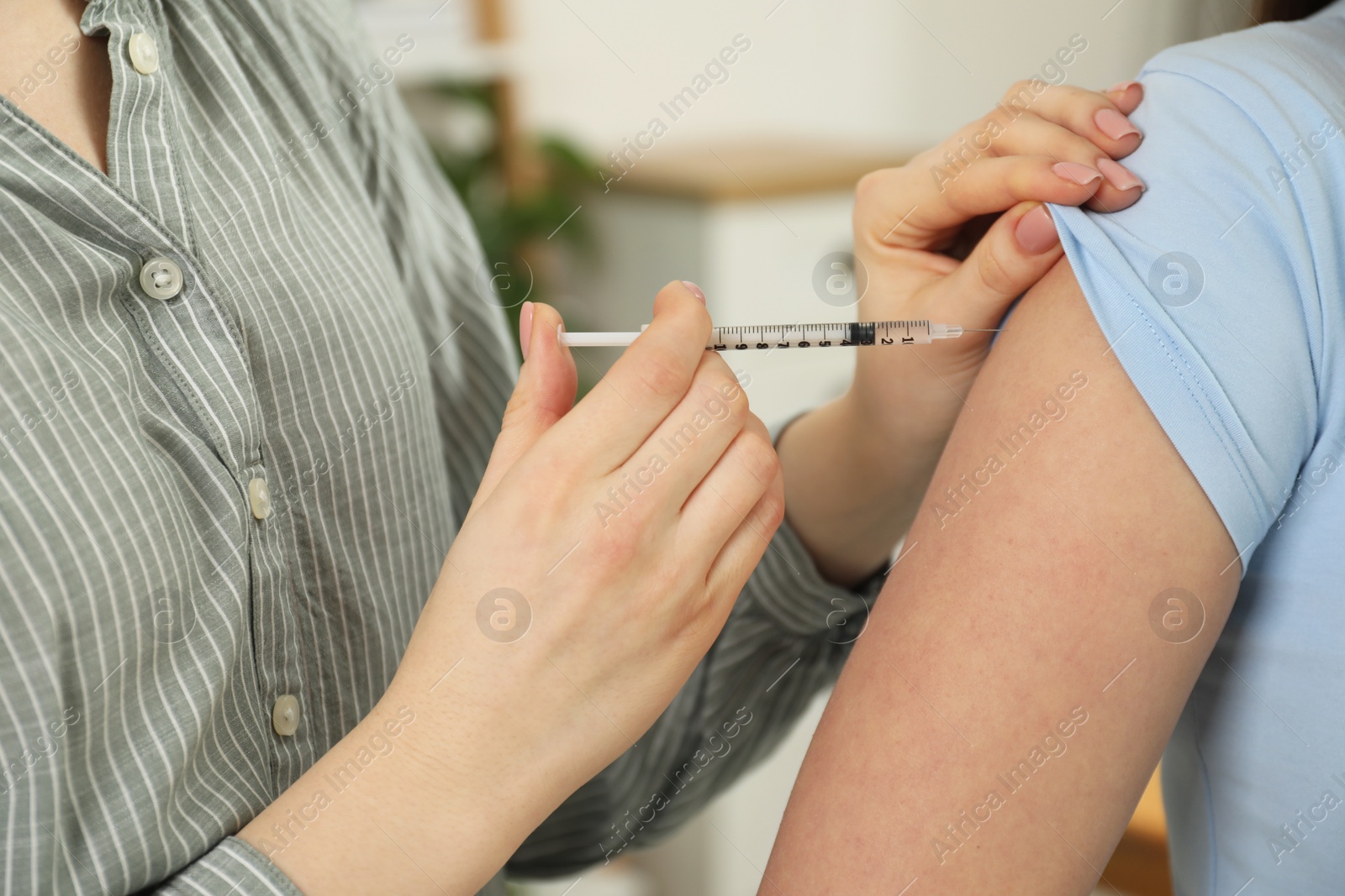 Photo of Diabetes. Woman getting insulin injection indoors, closeup