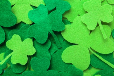 Photo of Decorative clover leaves as background, top view. St. Patrick's Day celebration