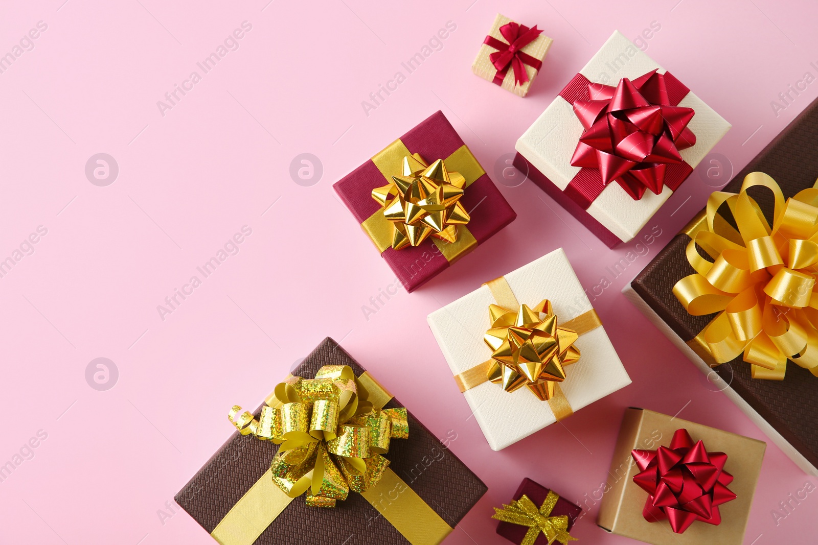 Photo of Flat lay composition with beautiful gift boxes on pink background. Space for text