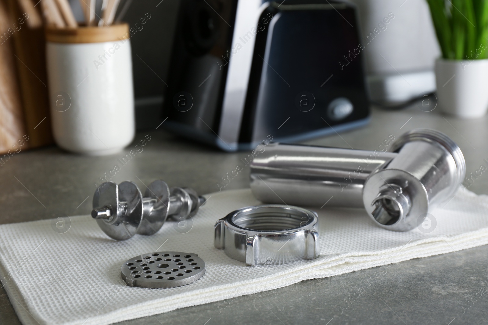 Photo of Clean parts of electric meat grinder on grey table indoors