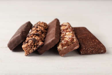 Photo of Tasty protein bars on white table. Healthy snack