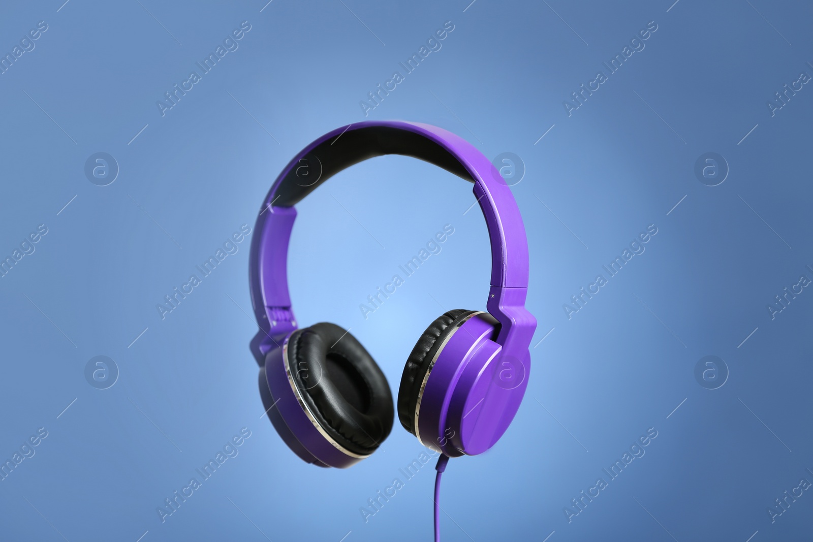 Photo of Stylish headphones with pads on color background