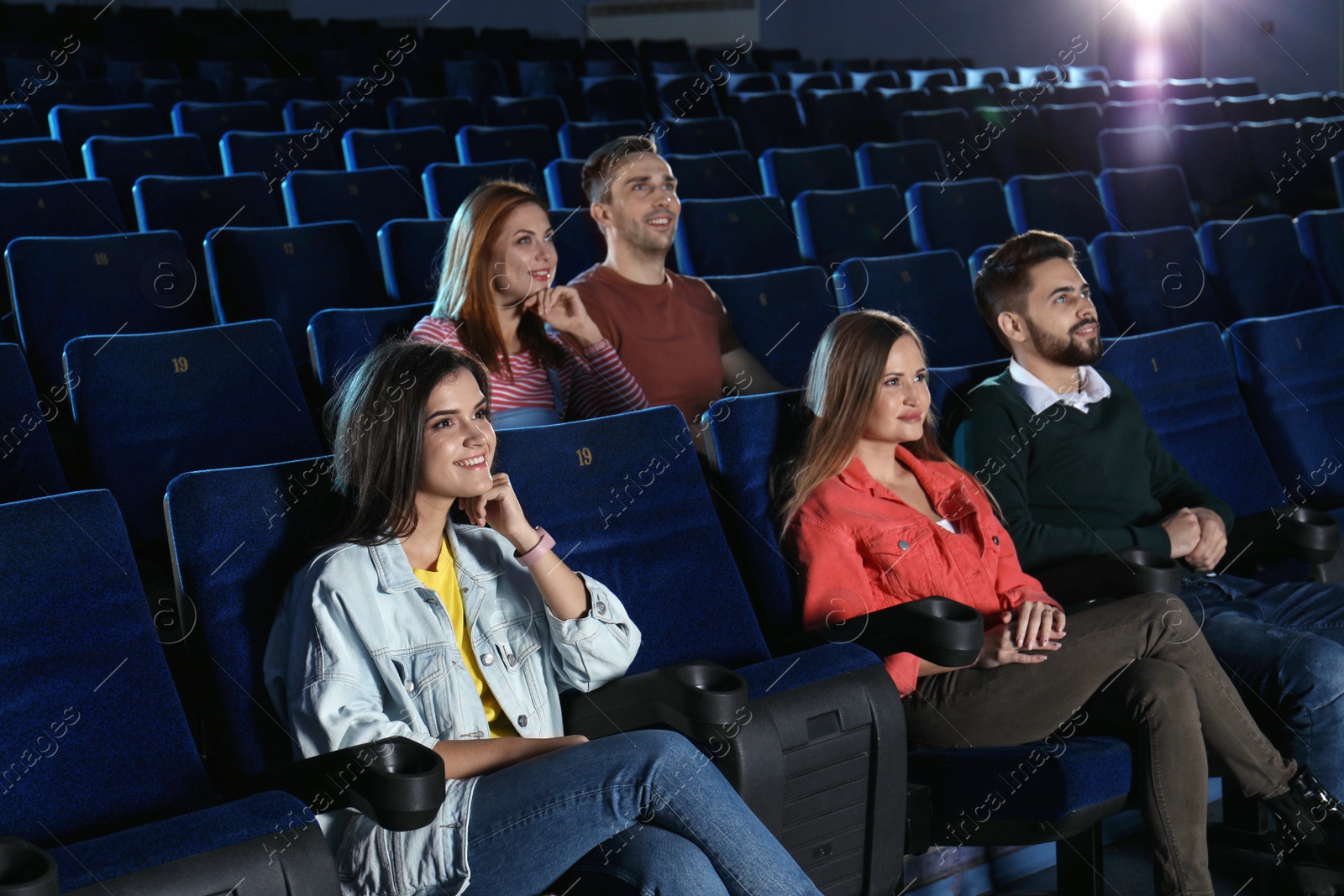 Photo of Young people watching movie in cinema theatre