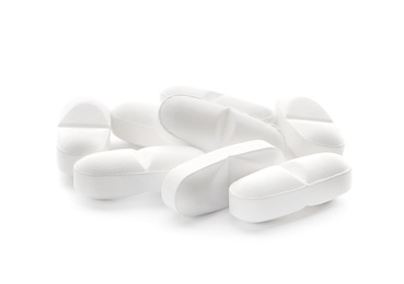 Photo of Heap of pills on white background
