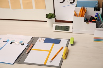 Photo of Business process planning and optimization. Documents with different types of graphs and stationery on wooden table