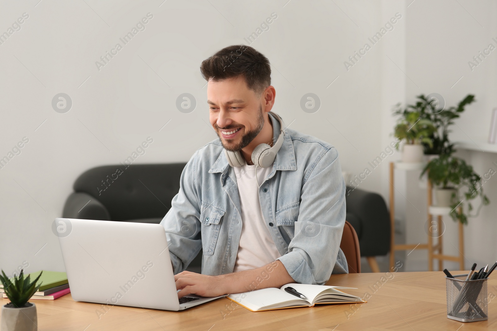 Photo of Online translation course. Man typing on laptop at home