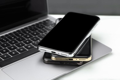 Photo of Stack of electronic devices on white table