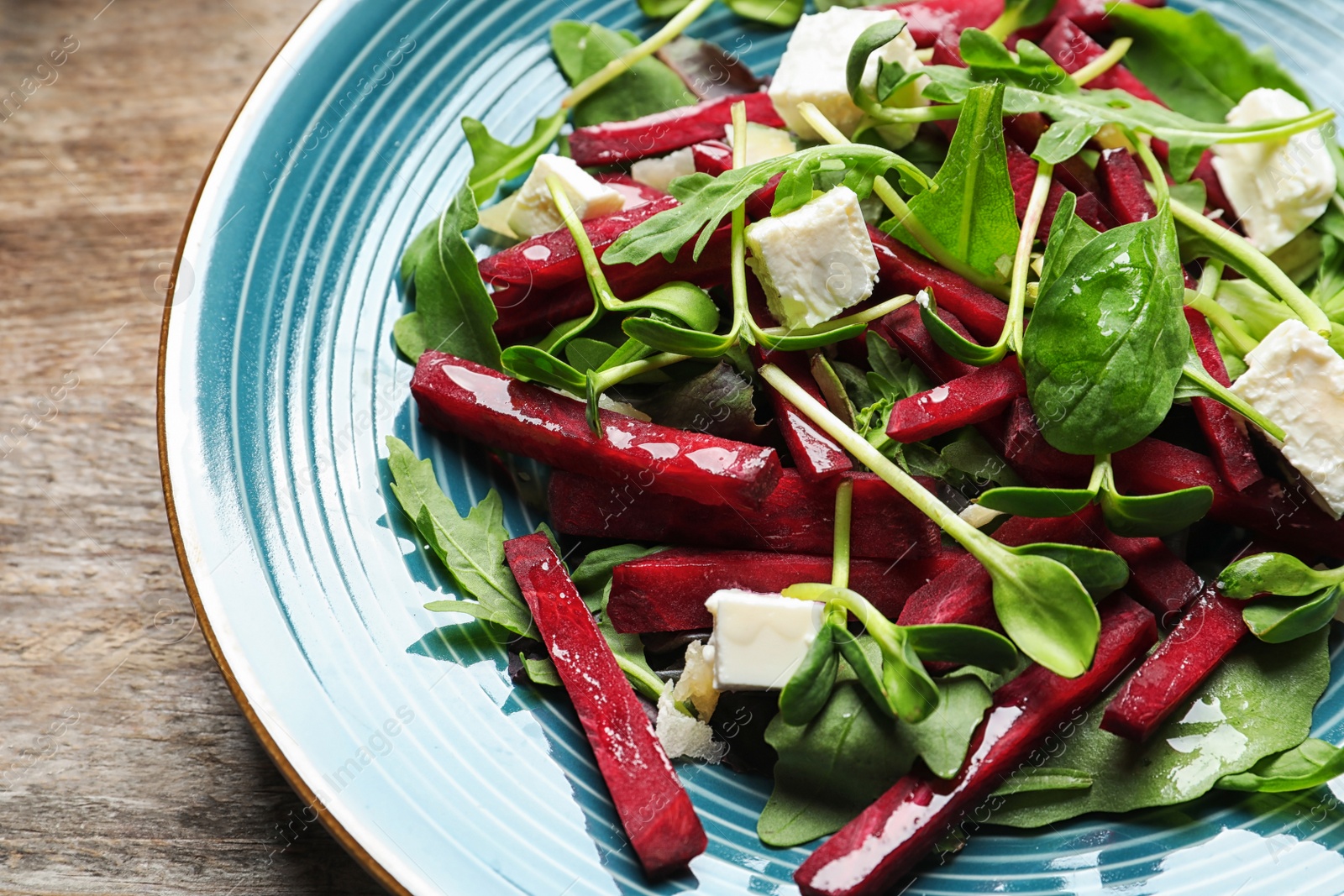 Photo of Plate with delicious beet salad on table, closeup