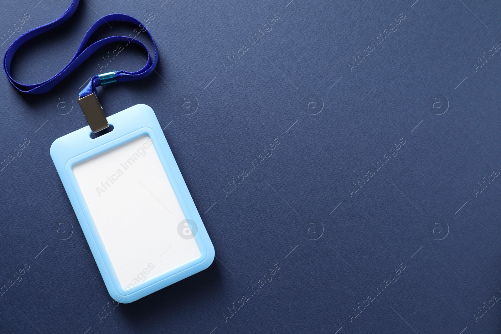 Photo of Blank badge with string on blue background, top view. Space for text