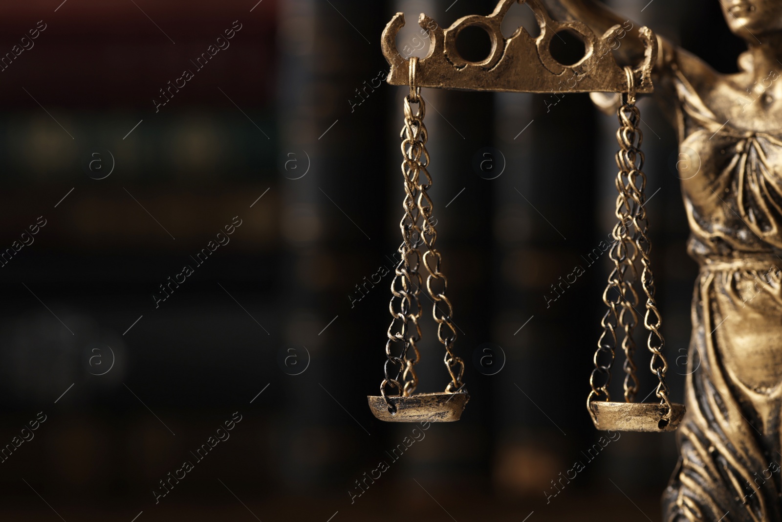 Photo of Symbol of fair treatment under law. Statue of Lady Justice on blurred background, closeup with space for text