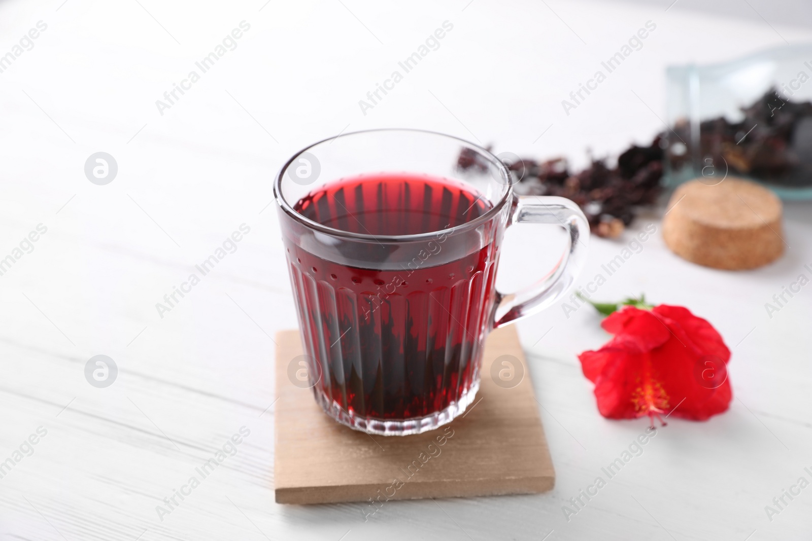 Photo of Delicious hibiscus tea on white wooden table