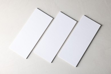 Photo of Blank business cards on light textured background, top view. Mockup for design