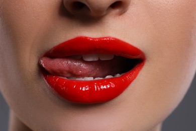 Photo of Young woman with beautiful red lips, closeup