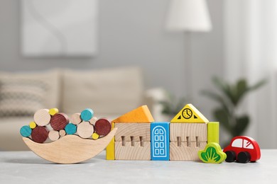 Photo of Set of wooden toys on light grey table indoors. Children's development