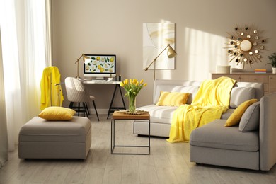 Photo of Stylish living room with sofa. Interior design in grey and yellow colors